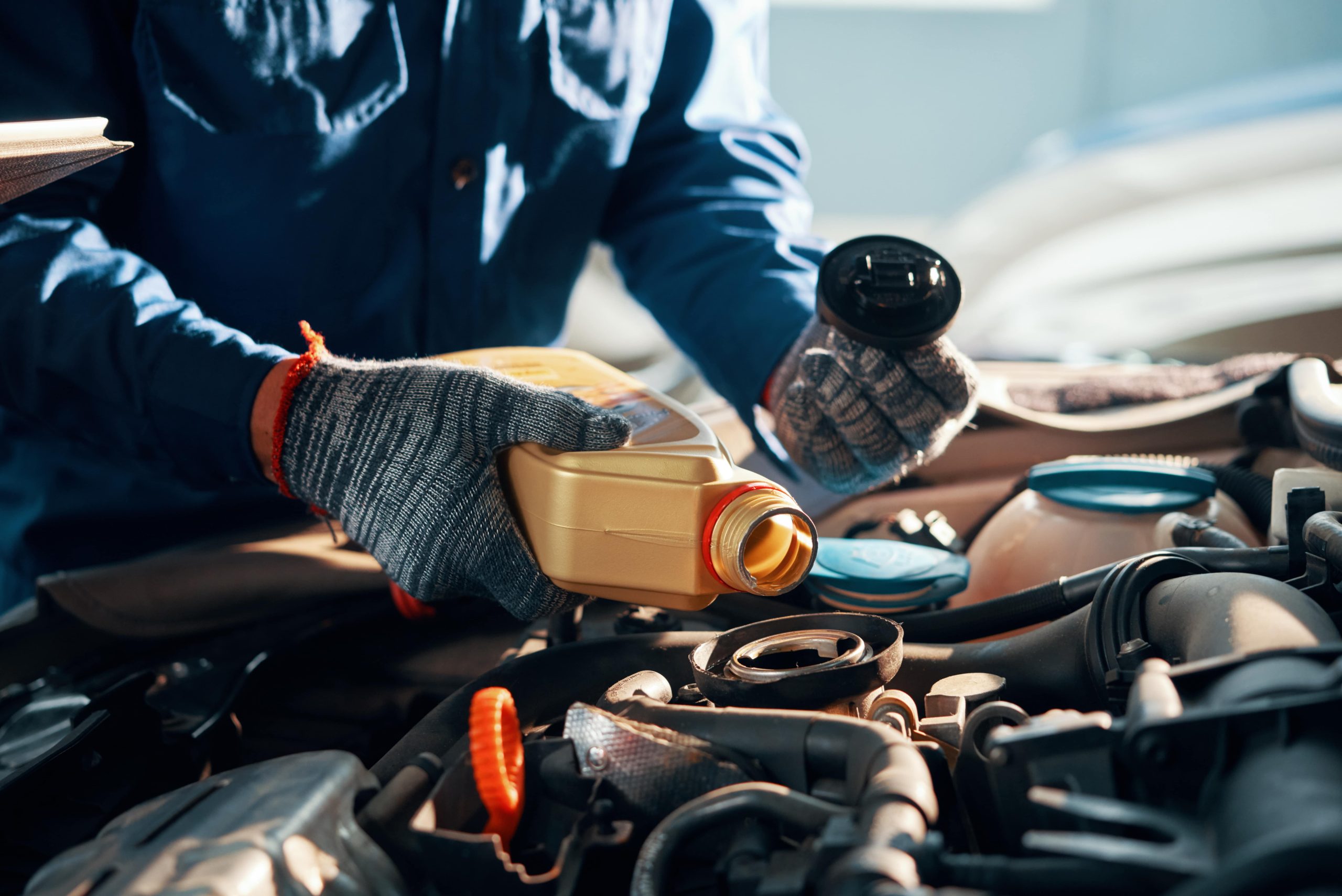 Mechanic adding transmission fluid to a chevy vehicle